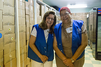 Two Smiling Volunteers at a Food Pantry